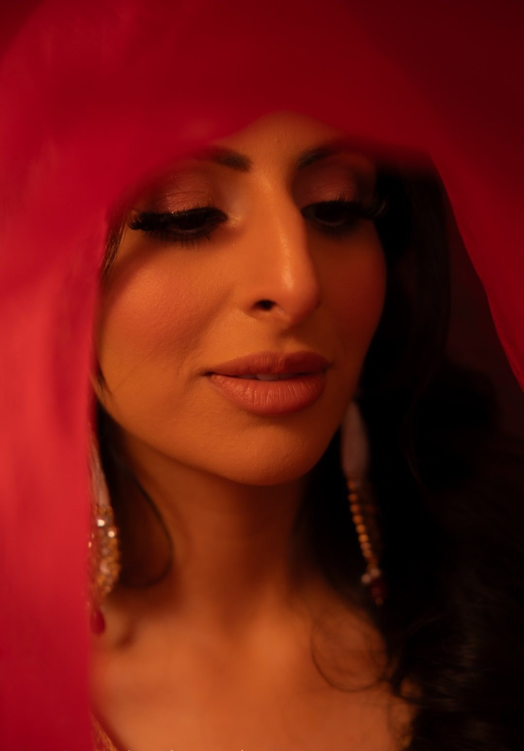 Portrait beneath a red veil